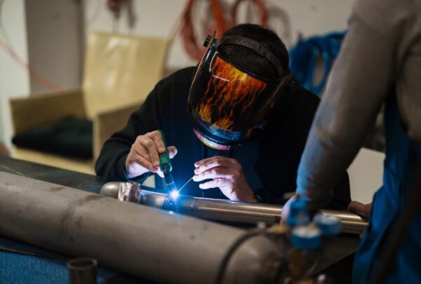 man-working-with-argon-welding-machine-garage man-working-with-argon-welding-machine-garage