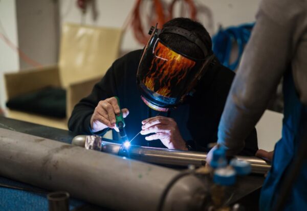 man-working-with-argon-welding-machine-garage