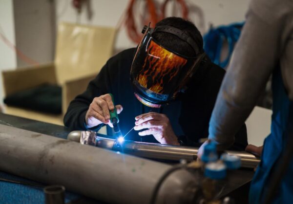 man-working-with-argon-welding-machine-garage man-working-with-argon-welding-machine-garage